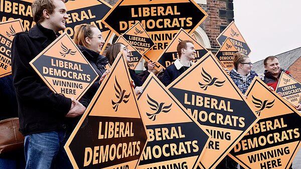 Lib Dem supporters hold signs